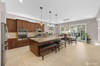 Beautiful kitchen with eating space and island with sink.