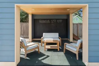 Covered section of the detached outdoor structure, adding charm and flexible exterior use.