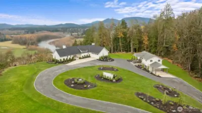 This property spans 18.5 acres of parklike grounds adorned with towering old-growth trees, sweeping territorial views, professional landscaping with lighting and circular driveway with curbing detail!