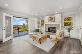 Cozy hearth room off kitchen with brick fireplace and French door access to deck with panoramic views!
