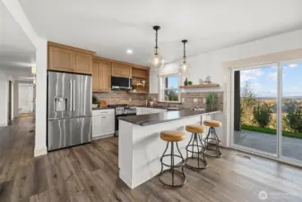 Beautiful custom kitchen with honed granite countertops, LG stainless steel appliance package, custom brick backsplash and bar seating! Perfect entertaining space or multigenerational living! Access to covered patio with amazing territorial views.
