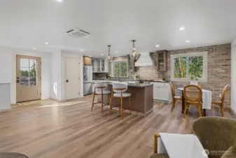 Spacious, open concept floor plan with custom kitchen with island, LVP flooring throughout, utility closet and Mitsubishi mini split too.