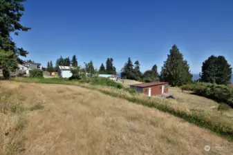 Looking north from the upper level of the lot. Please know that the drainfield of Lot 1 is located in this grassy area. An easement has been recorded.