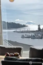 Mt Rainier is starting to poke out from morning fog.