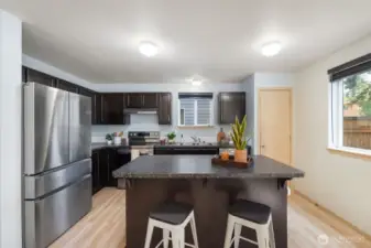 The kitchen features stainless steel appliances and an eat-in space.