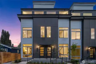 Welcome to the Arlo Community in Wallingford by Greencity Homes! This home has a twilight curb appeal with a modern flair—clean lines, expansive windows, and striking contrast come alive at dusk. It makes an unforgettable first impression.