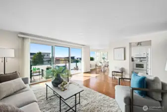 Discover this bright Shoreline condo!   A light filled living room opens to your private view deck, showcasing captivating partial view of the Sound and territory.
