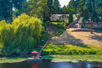 The stunning lakefront home has a park-like path to the waterfront, where the destination dock includes your personal pontoon boat perfect for the holiday pontoon boat parades on Trout Lake.