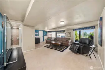 The lower level includes a spacious family room and full kitchen just ahead.  Notice the great back yard access and view.