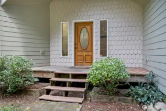 Scalloped detailed siding greets you at the entrance of this charming home.
