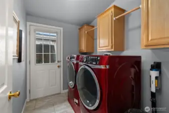 Spacious utility room with cabinetry, and outdoor access.