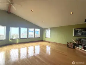Huge living room/dining area with wall of windows showcasing the incredible ocean views