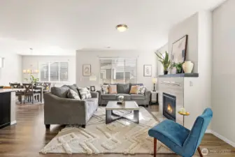 Open light and bright living room with gas fireplace.