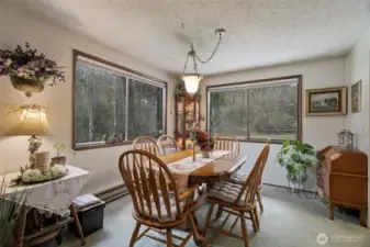 Lovely and good sized dining room with large windows that give an amazing backdrop for any meal. Plenty of space for a sideboard, Extended table and open to living room - great for large gatherings!