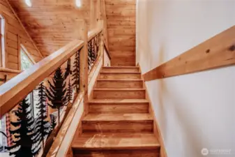 Custom staircase leads to an upper loft (3rd bedroom) with ensuite bath