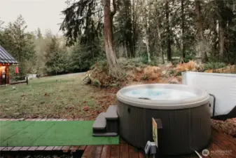 The deck extends off the back porch to the hot tub for post-slope relaxation