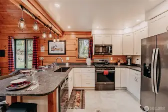 The gourmet kitchen beautifully blends rustic accents with modern design and features counter seating & walk-in pantry