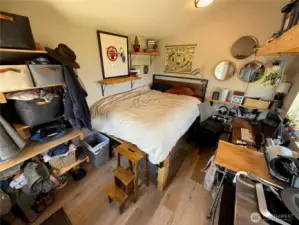 Efficiently designed living area with plentiful storage above and below raised bed.