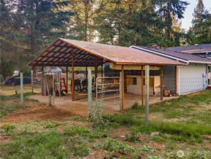 Fenced enclosure with concrete pad and roof