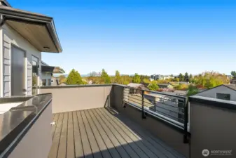 The rooftop deck serves panoramic views of the city and treetops, giving you a front-row seat to sunset skies.