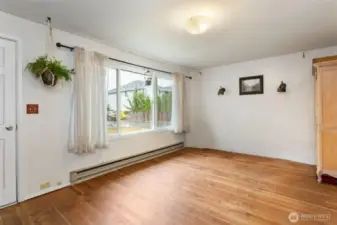 Living room as it is currently with carpet removed.  Hardwood floors were underneath and seller liked them better.