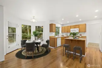 A virtual staged version of the kitchen and kitchen eating area.