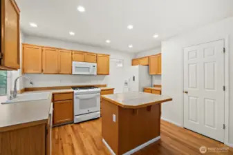 "Enjoy cooking on the newer gas cooktop and oven with built-in air fryer! The door on the right leads to a roomy pantry.