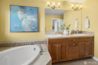 Primary ensuite featuring dual vanities.