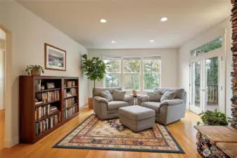 The other side of the huge living room makes a great spot to sit & read. The double glass doors lead to the deck.