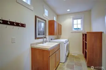 The laundry room has a utility sink & storage.