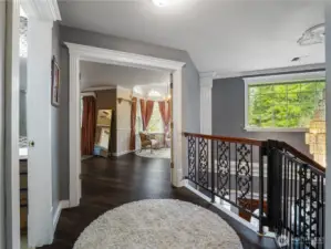 upstairs landing area with inviting french doors to primary bedroom