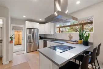 Open concept kitchen and the breakfast bar make for an easy flow.