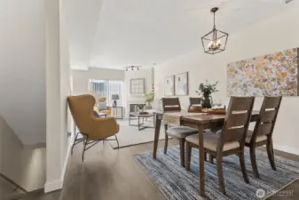 Up the stairs, you will enter into the large, open great room, where the living space, dining area and kitchen all flow into one. Modern living is enhanced with smart home upgrades throughout, including smart light switches, a smart thermostat, a smart garage door opener, and an EV charger outlet—perfect for eco-conscious buyers or anyone seeking added convenience and efficiency.