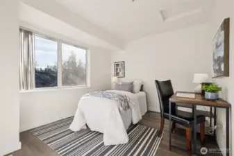 The second bedroom is also well-sized and is served by a full hallway bathroom with thoughtful updates, making it ideal for guests, a home office, or a second bedroom.