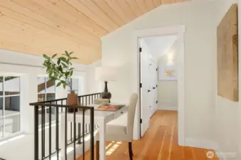 Explore the upstairs spaces and find a custom work space at the top of the stair landing. Solid wood flooring graces the upstairs bedroom spaces.