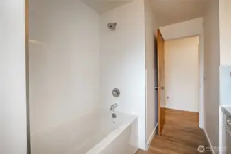 Hall bathroom features new bathtub & tile surround.