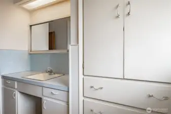 Hall bathroom with extra cabinets for storage.