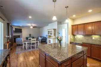 From the kitchen, take in the open view of the family and dining areas—plus extra cabinetry and granite counter space to the right.