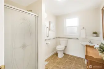 Large bathroom with accessible toilet features.