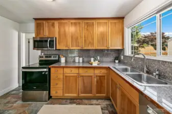 Kitchen sink window overlooks the backyard.