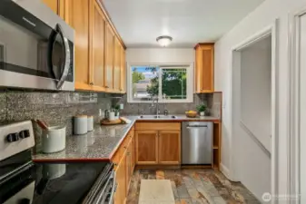 Kitchen has direct access to the backyard and the high ceiling basement.