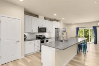Look at that chef's island! Oversized kitchen island comfortably seats 6-8! Roomy walk-in pantry to the left.