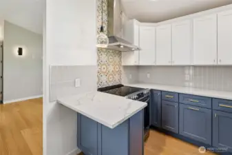 Vaulted Ceilings extend into the kitchen area.  Tile backsplash all the way around