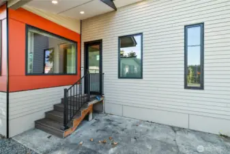 Gorgeous entry with black vinyl windows, solid entry door, & maintenance free deck