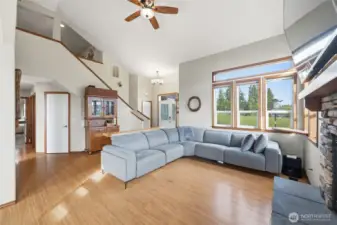 Living room to entryway. That hallway leads to an office/bedroom and the primary bedroom, half bath, and laundry room.
