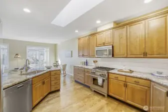 Kitchen with Wolf range, JennAir refrigerator and a Miele dishwasher