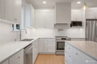 Kitchen with pot filler and plaster range hood