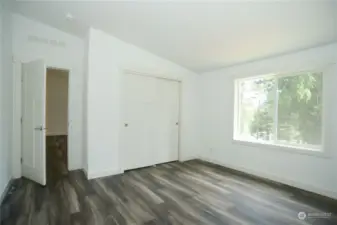 Spacious primary bedroom has an attached ensuite and lots of closet space.