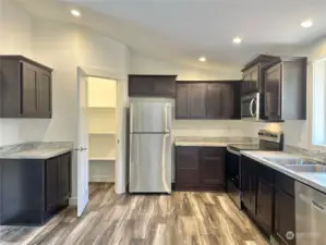 Open concept kitchen with tons of space and large pantry.