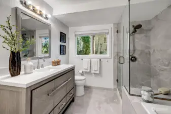 Soaking tub and large walk-in shower in the primary bathroom.